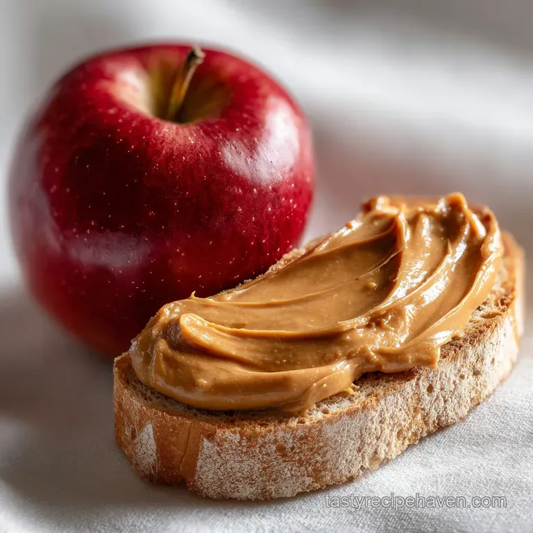 Artistically arranged apple wedges spread with peanut butter, sprinkled with granola and drizzled honey on a white plate. ...